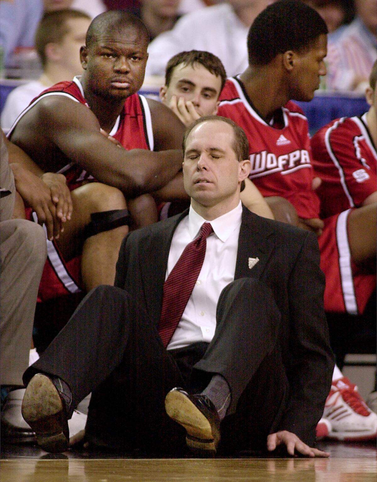 Herb Sendek sits back on the floor as his team trails the Duke Blue Devils during second half action in 2001.