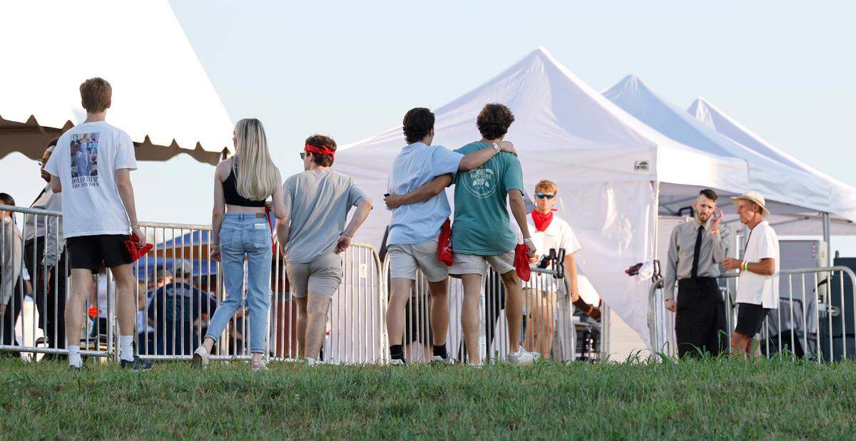 Attendees arrive at “Flagstock 2024,” an invite-only concert featuring country musicians Big & Rich and Lee Greenwood, among others, at a location in Chapel Hill, N.C., Monday, Sept. 2, 2024. Flagstock started after a GoFundMe raised over $500,000 for a “rager” for UNC-Chapel Hill fraternity brothers who held up the American flag during an April campus protest.