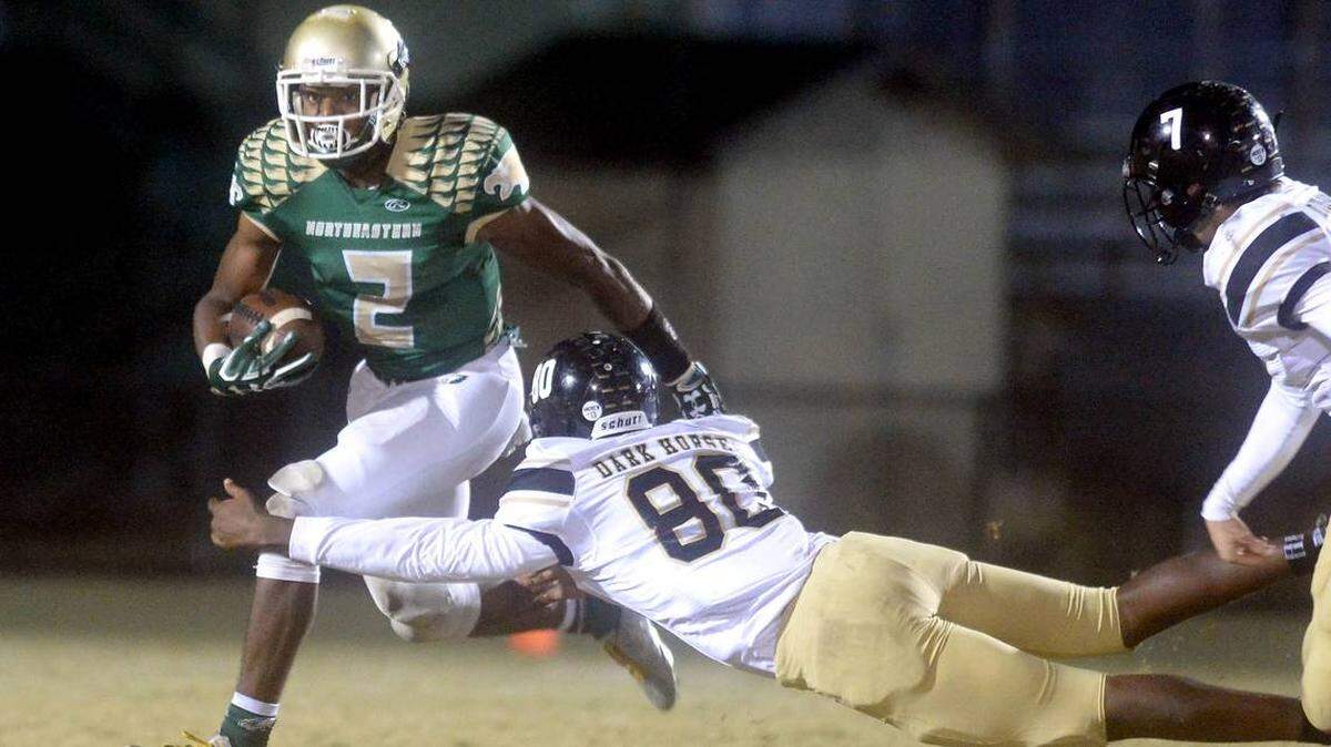J.R. Walker runs for extra yardage last season at Northeastern High School. Walker, one of the top athletes in the country, transferred to Clayton High School over the summer.