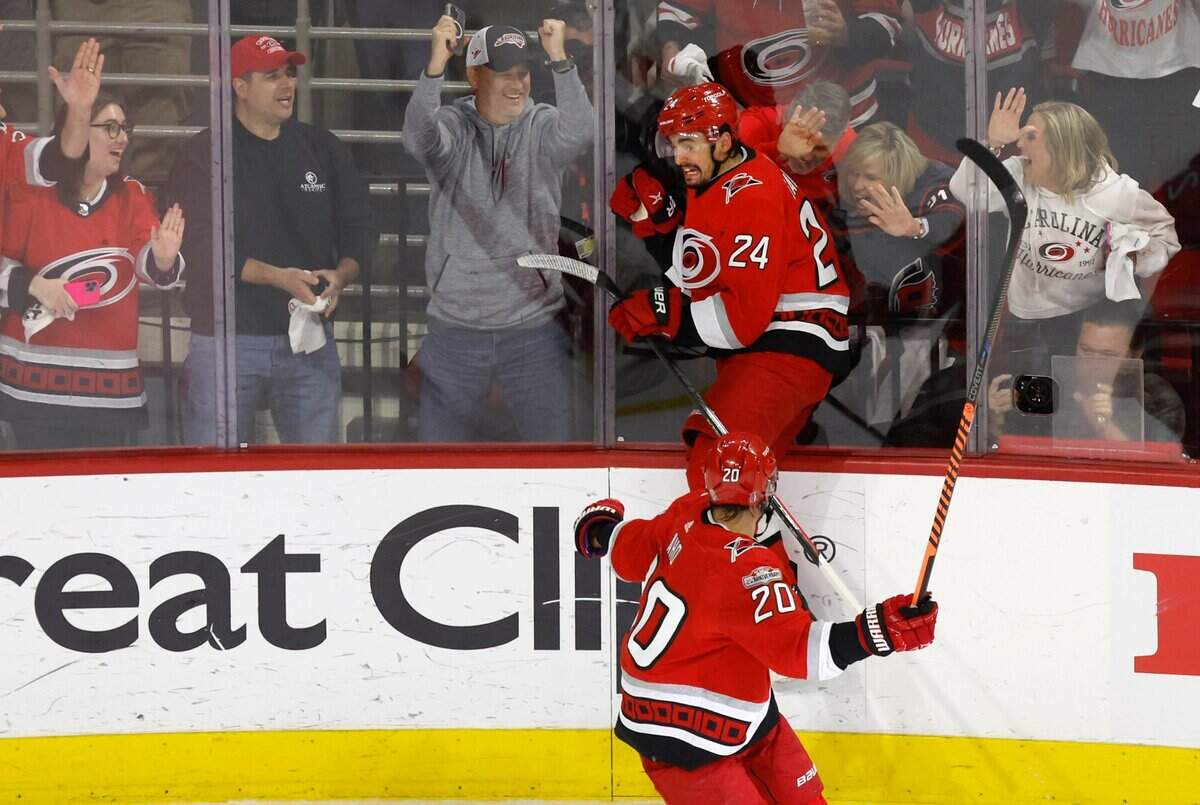 Carolina center Seth Jarvis (24) celebrates after scoring during the first period of the Hurricanes’ game against the Panthers in the first game of Eastern Conference Finals at PNC Arena in Raleigh, N.C., on Thursday, May 18, 2023. Carolina center Sebastian Aho (20) comes in to join him.