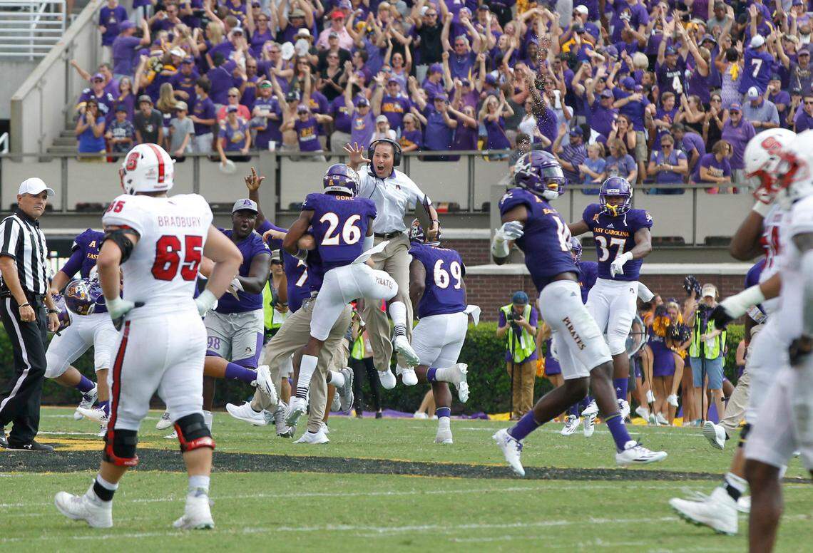 East Carolina players celebrate as time runs out in the game during ECU’s 33-30 victory over N.C. State at Dowdy-Ficklen Stadium in Greenville in 2016.