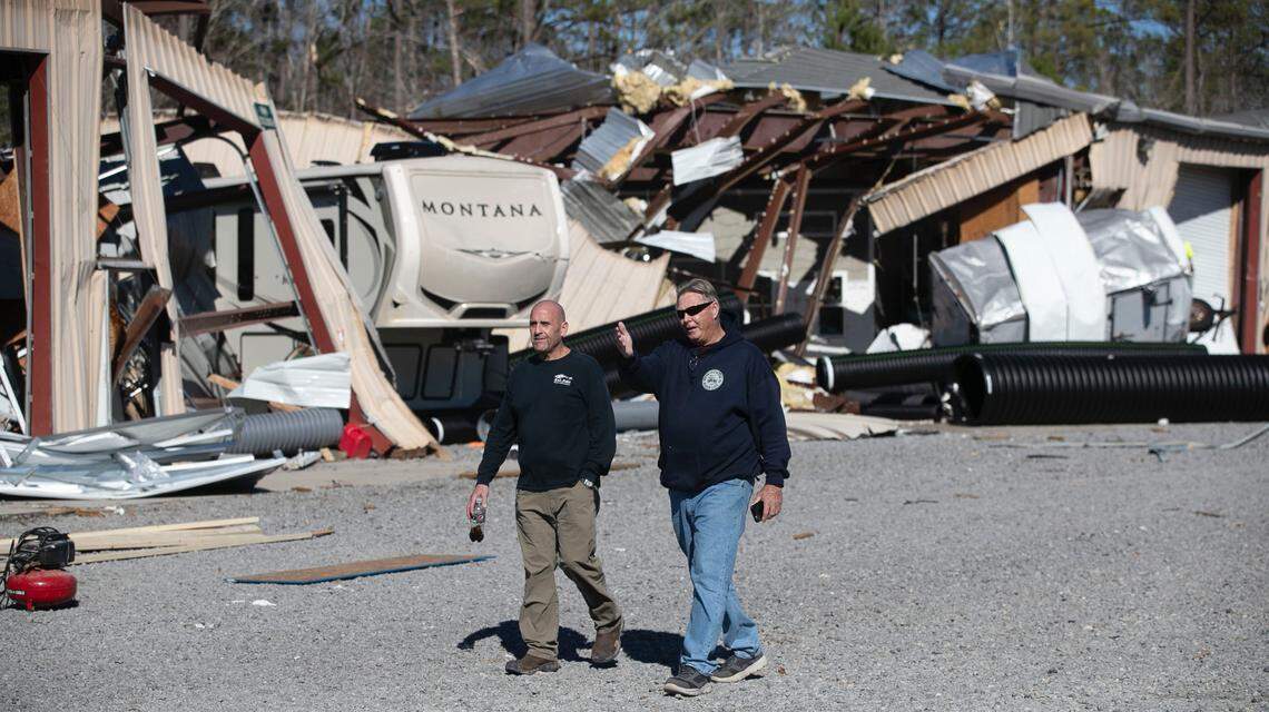 Rich Dobkin, left the owner of Ocean Ridge Storage Solutions and Rich Jensen survey the damage to Dobkin’s business on Tuesday, February 16, 2021 after a tornado ripped through the Brunswick County community late Monday night. The storage suffered extensive damage.