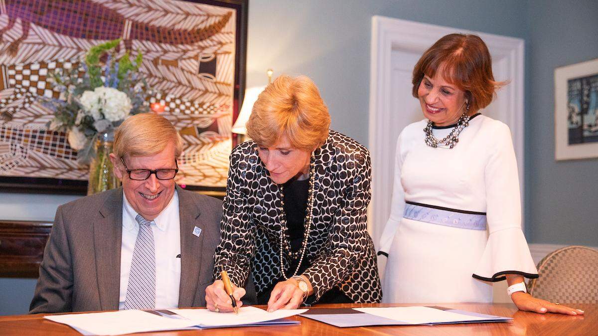 Don Curtis, Dean Susan King of the UNC School of Media and Journalism and UNC Chancellor Carol Folt sign documents related to the Curtis Foundation gift of $21.75 million.