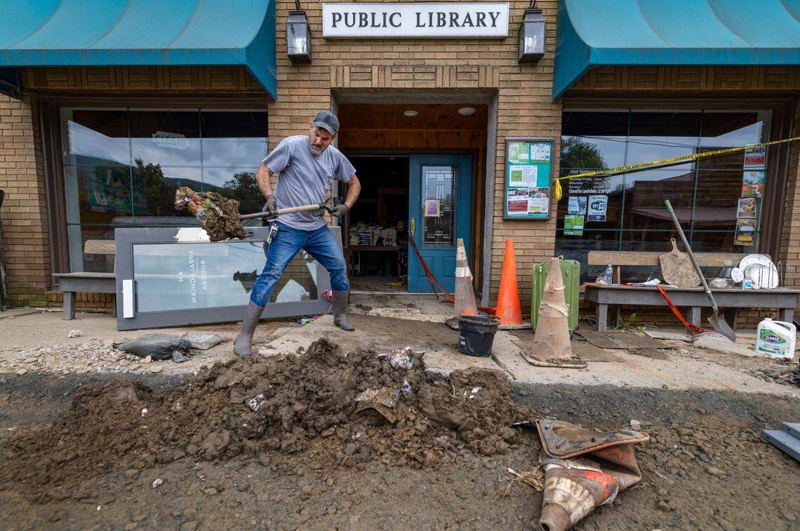 Volunteer Justin Moon shovels mud from the public library on Friday, October 4, 2024 in Hot Springs, N.C after flood waters from Hurricane Helen filled the building one week ago.