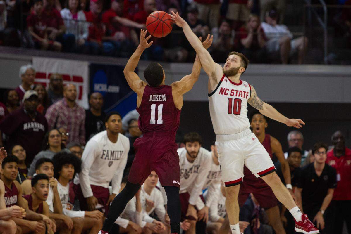 N.C. State’s Braxton Beverly (10) contests Harvard’s Bryce Aiken (11) during final seconds of the second half of the second round of the NIT at Reynolds Coliseum Sunday, March 24, 2019. N.C. State won 78-77.
