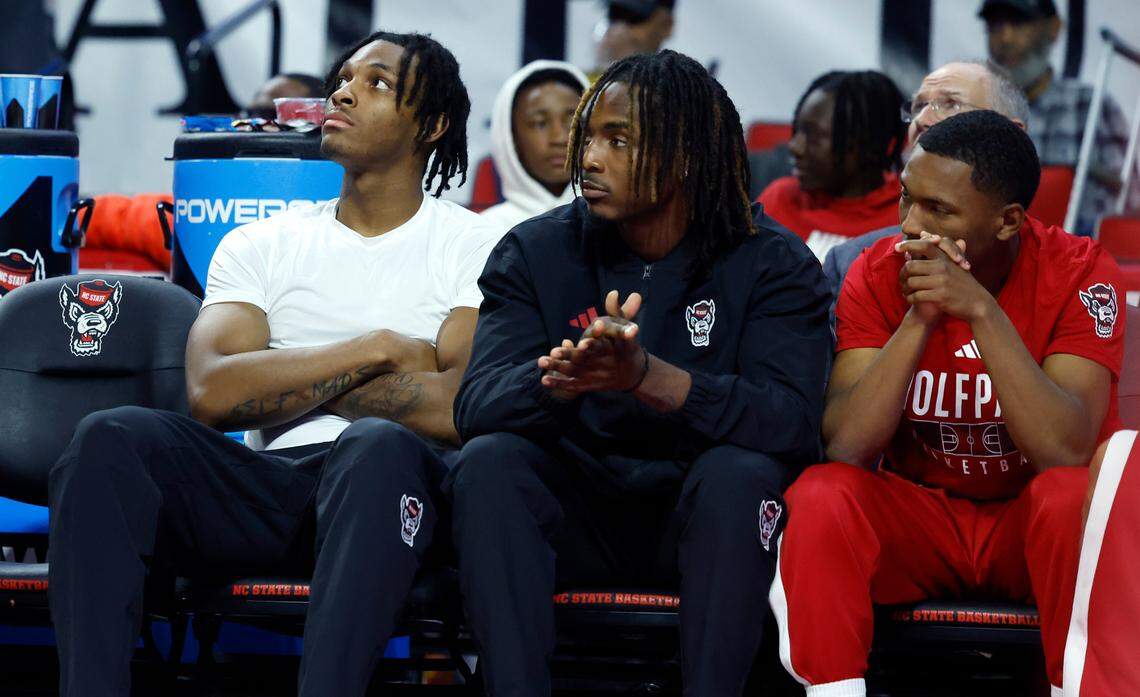 N.C. State’s MJ Rice, left, Kam Woods, center, and KJ Keatts watch during the second half of N.C. State’s 89-76 exhibition victory over Mount Olive at PNC Arena in Raleigh, N.C., Wednesday, Nov. 1, 2023.