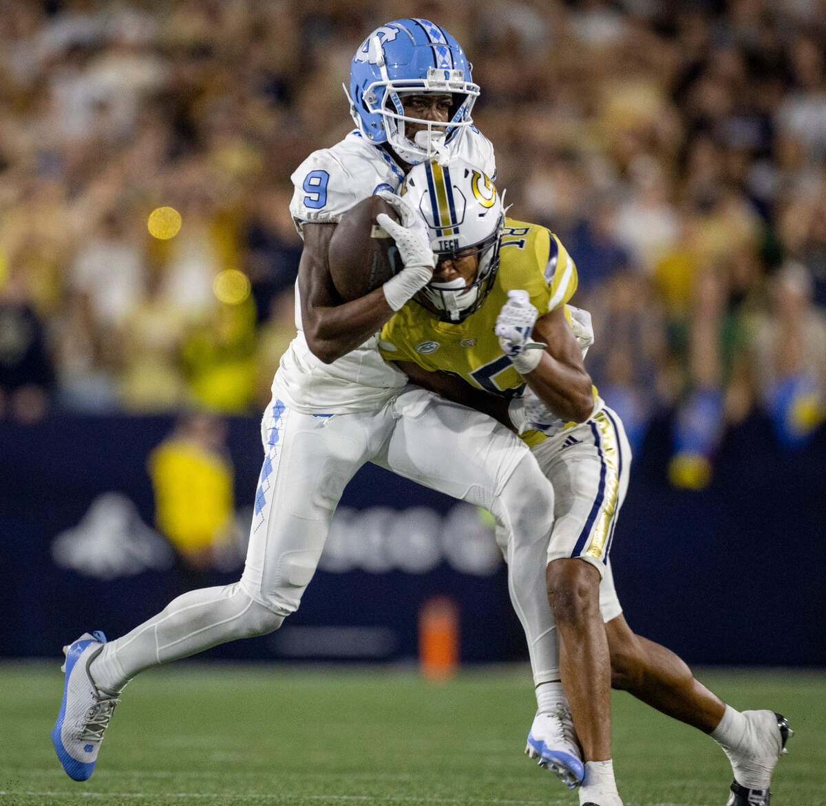 Georgia Tech’s Ahmari Harvey (18) collides with North Carolina’s Devontez Walker (9), forcing a fumble, after a 36-yard pass completion from quarterback Drake Maye with 2:54 to play in the game, securing a 46-42 victory for the Yellow Jackets on Saturday, October 28, 2023 at Bobby Dodd Stadium in Atlanta, Georgia.