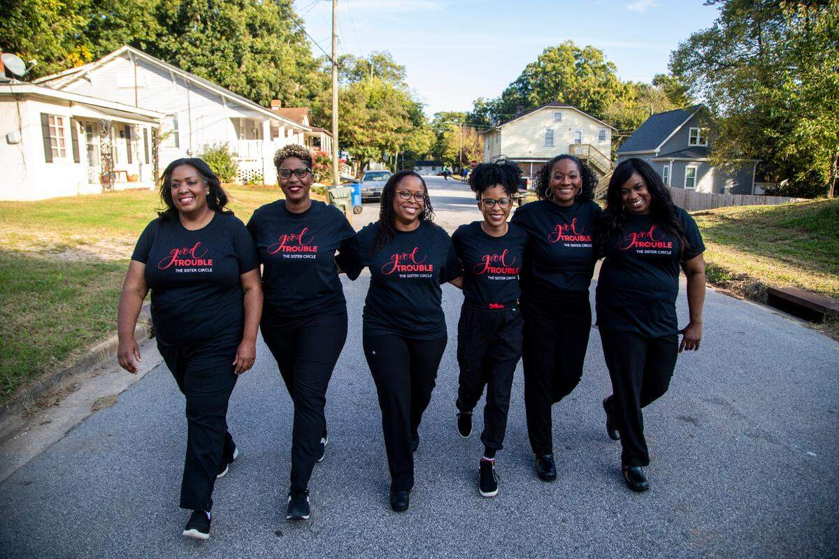 WakeMed doctors, collectively known as the Sister Circle, are from left: Nerissa Price, Rasheeda Monroe, Michele Benoit-Wilson, Jacqueline Hicks, Tiffany Lowe-Payne and Netasha McLawhorn. They walk together while filming a WakeMed commercial. The group helped bring COVID-19 vaccines to Black and marginalized residents of Southeast Raleigh.
