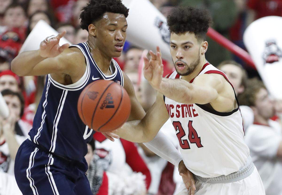 N.C. State’s Devon Daniels (24) fights for the rebound with Duke’s Wendell Moore Jr. (0) during the first half of Duke’s game with N.C. State at PNC Arena in Raleigh, N.C., Wednesday, Feb. 19, 2020.