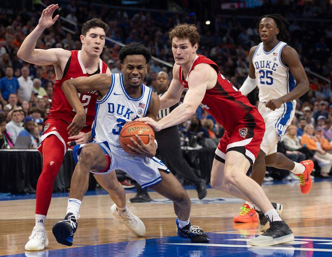 N.C. State’s Michael O’Connell (12) and Ben Middlebrooks (34) slow Duke’s Jeremy Roach (3) as he drives to the basket during the second half in the quarterfinals of the ACC Men’s Basketball Tournament at Capitol One Arena on Wednesday, March 13, 2024 in Washington, D.C.