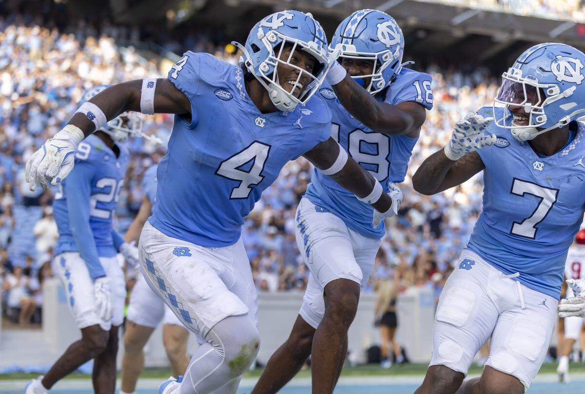 North Carolina Mikia Gbayor (4) celebrates with teammates after 62-yard fumble recovery for a touchdown to give the Tar Heels’ a 34-3 lead in the fourth quarter against Richmond on Saturday, September 13, 2025 at Kenan Stadium in Chapel Hill, N.C.