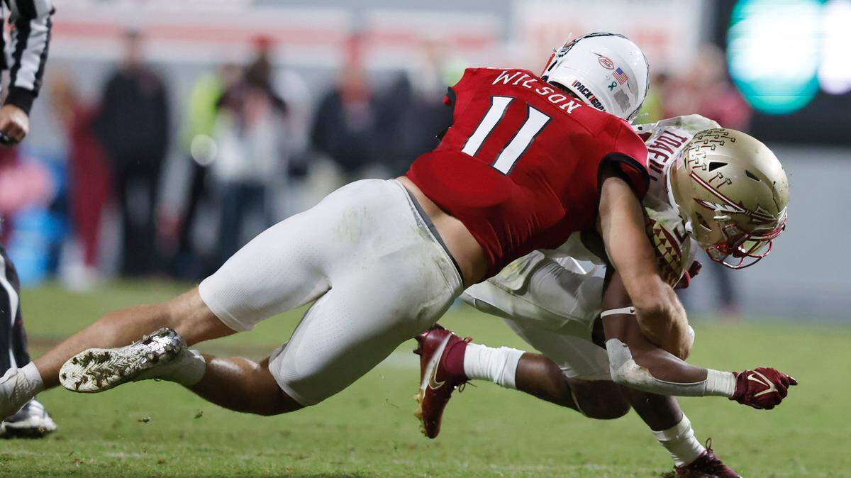 N.C. State linebacker Payton Wilson (11) tackles Florida State running back Lawrance Toafili (9) during the second half of N.C. State’s 19-17 victory over Florida State at Carter-Finley Stadium in Raleigh, N.C., Saturday, Oct. 8, 2022.