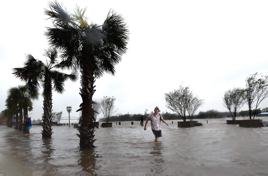 Zach Sullivan walks down a flooded Water Street as the Cape Fear River overflows it’s banks as Hurricane Florence made landfall Friday Sept. 14, 2018.  