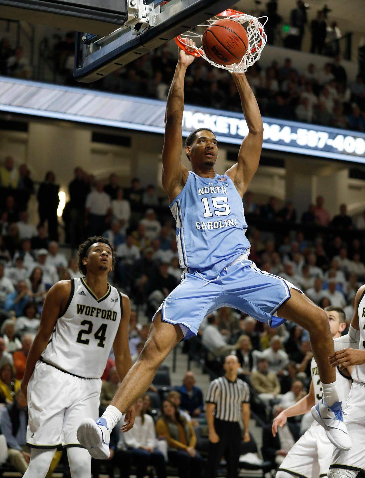 North Carolina’s Garrison Brooks (15) dunks over Wofford’s Keve Aluma (24) during the first half of an NCAA college basketball game in Spartanburg, S.C., Tuesday, Nov. 6, 2018. 