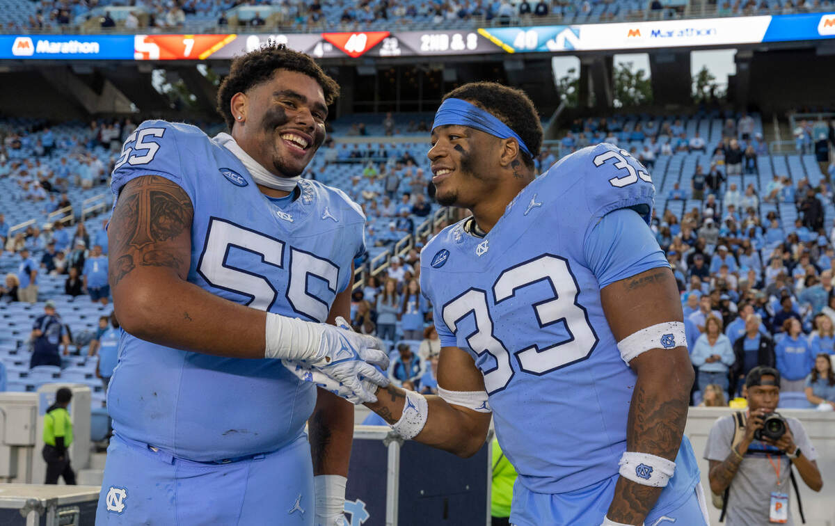 North Carolina’s Cedric Gray (33) and teammate Zach Rice (55) celebrate the Tar Heels’ 40-7 victory over Syracuse on Saturday, October 7, 2023 at Kenan Stadium in Chapel Hill, N.C.