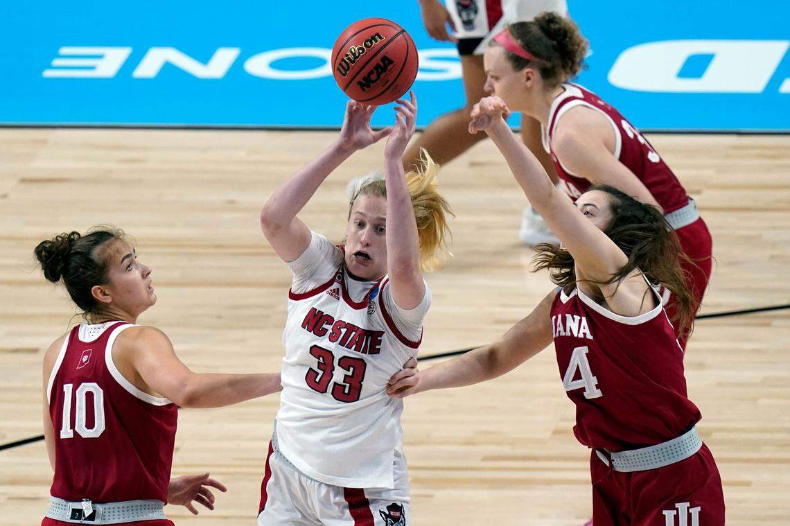 North Carolina State center Elissa Cunane (33) is pressured by Indiana forward Mackenzie Holmes, right, and Indiana forward Aleksa Gulbe (10) during the first half of a college basketball game in the Sweet Sixteen round of the women’s NCAA tournament at the Alamodome in San Antonio, Saturday, March 27, 2021.