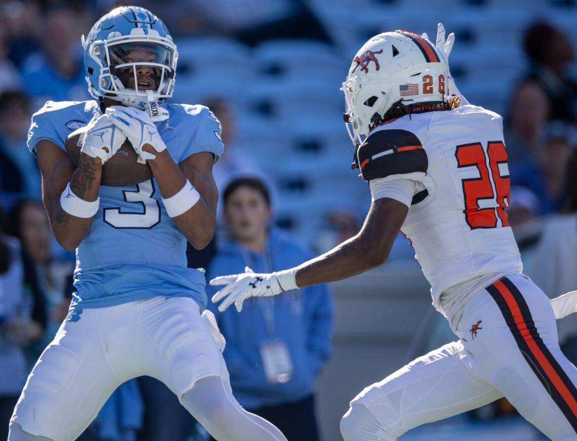 North Carolina’s Chris Culliver (3) secures a 41-yard pass from quarterback Conner Harrell for a touchdown ahead of Campbells’ Ronald Bullard (26) to give the Tar Heels’ a 59-7 lead in the fourth quarter on Saturday, November 4. 2023 at Kenan Stadium in Chapel Hill, N.C.
