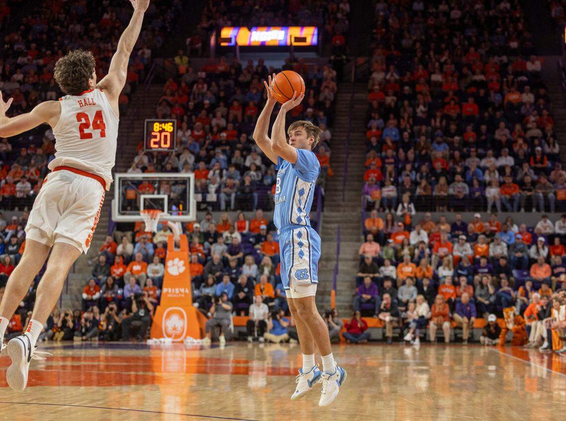 North Carolina’s Paxson Wojcik (8) shoots a three point basket against Clemson’s P.J. Hall (24) to give the Tar Heels’ a three point lead in the second half on Saturday, January 6, 2024 at Littlejohn Coliseum in Clemson, S.C.