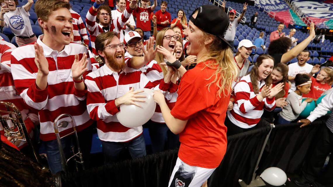 N.C. State’s Elissa Cunane (33) celebrates with the pep band after the Wolfpack’s 71-66 victory over the Florida State Seminoles in the ACC Tournament finals at Greensboro Coliseum in Greensboro, N.C., Sunday, March 8, 2020.