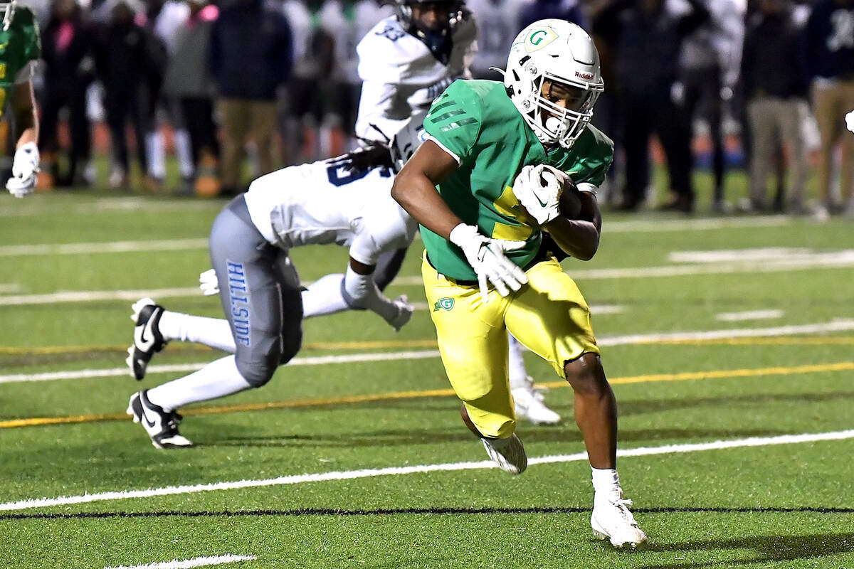 Cardinal Gibbons running back Kendall Scotton (5) sprints for the touchdown against Hillside during the first half. The Cardinal Gibbons Crusaders and the Durham Hillside Hornets met in the third round of the NCHSAA 4A playoffs in Raleigh, N.C. on November 29, 2024.