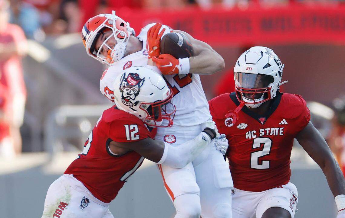 Clemson wide receiver Brannon Spector (13) makes the reception as N.C. State defensive back Devan Boykin (12) hits him during the first half of N.C. State’s game against Clemson at Carter-Finley Stadium in Raleigh, N.C., Saturday, Oct. 28, 2023.