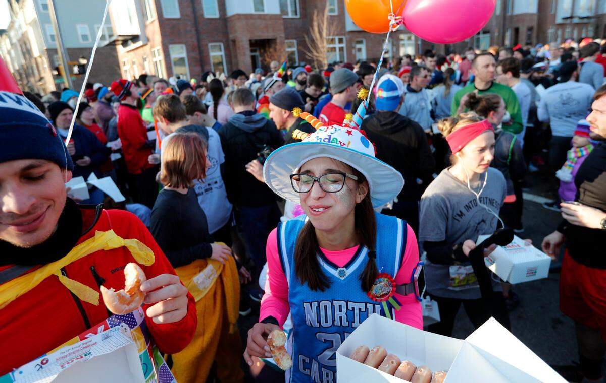Morgan Ferone eat doughnuts as she celebrates her 23rd birthday during the 15th annual Krispy Kreme Challenge in Raleigh, N.C., Saturday, Feb. 2, 2019.