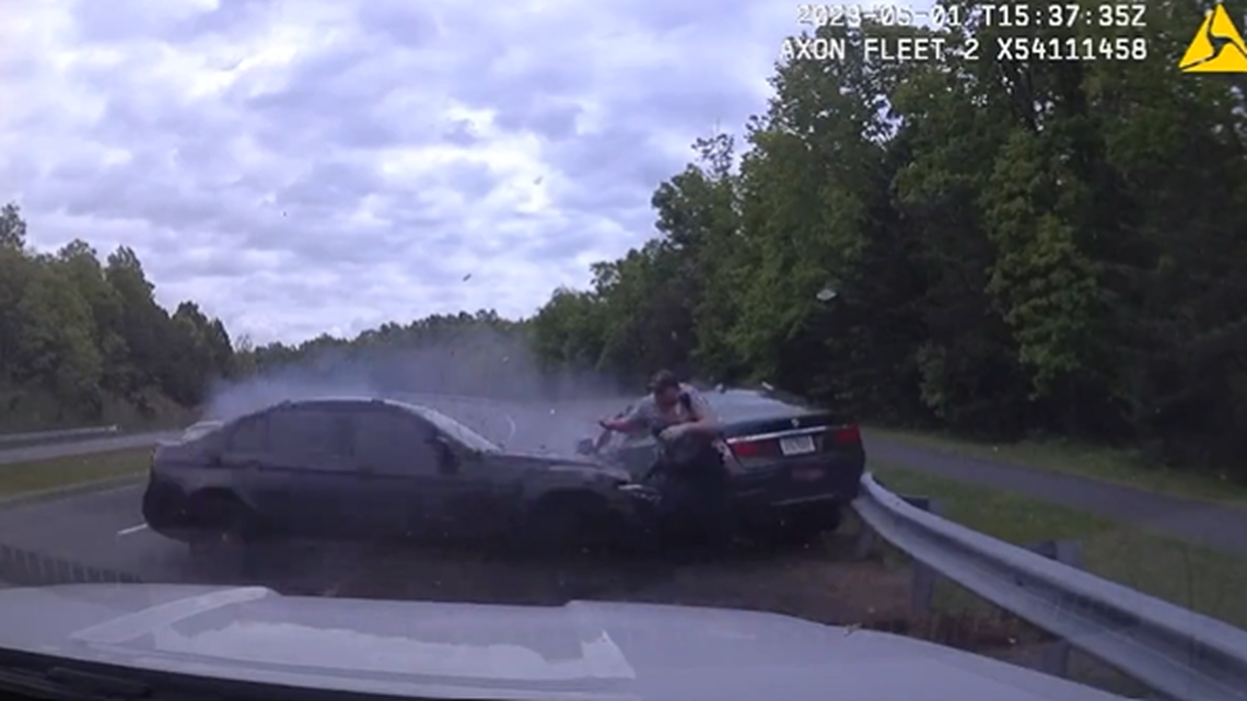 An officer was seen making a split-second decision to run for safety when a BMW came barreling toward him.