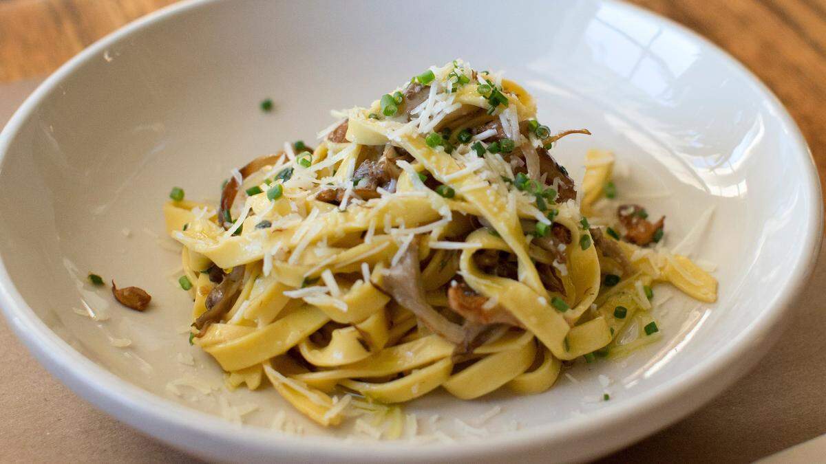 Hand-cut noodles with wild mushrooms tossed in garlic and topped with pecorino cheese, at Gocciolina’s.