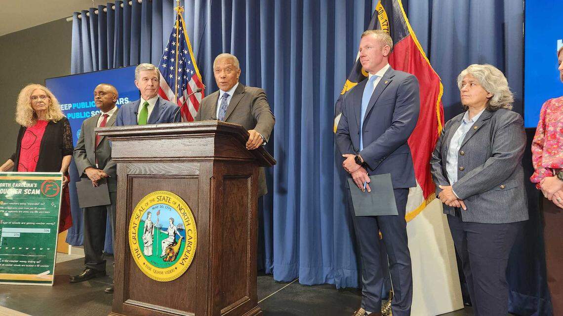 Senate Democratic Leader Dan Blue of Raleigh, at podium, talks about private school vouchers and planned votes in September at the N.C. General Assembly. From left, Rep. Cynthia Ball, House Democratic Leader Robert Reives, Gov. Roy Cooper, Blue, Sen. Michael Garrett and Sen. Lisa Grafstein, during a news conference at the Albemarle Building.