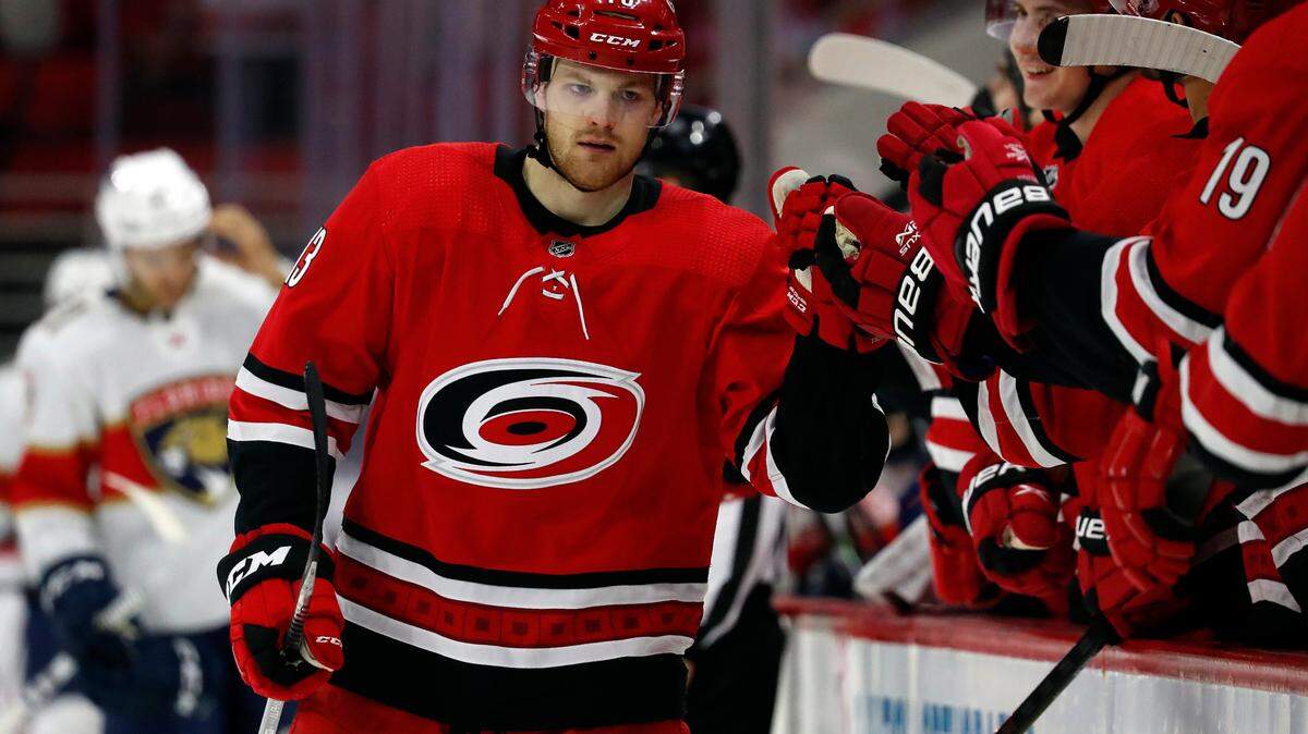 Carolina Hurricanes’ Warren Foegele (13) celebrates his goal along the bench during the third period of an NHL hockey game against the Florida Panthers in Raleigh, N.C., Sunday, March 7, 2021. (AP Photo/Karl B DeBlaker)