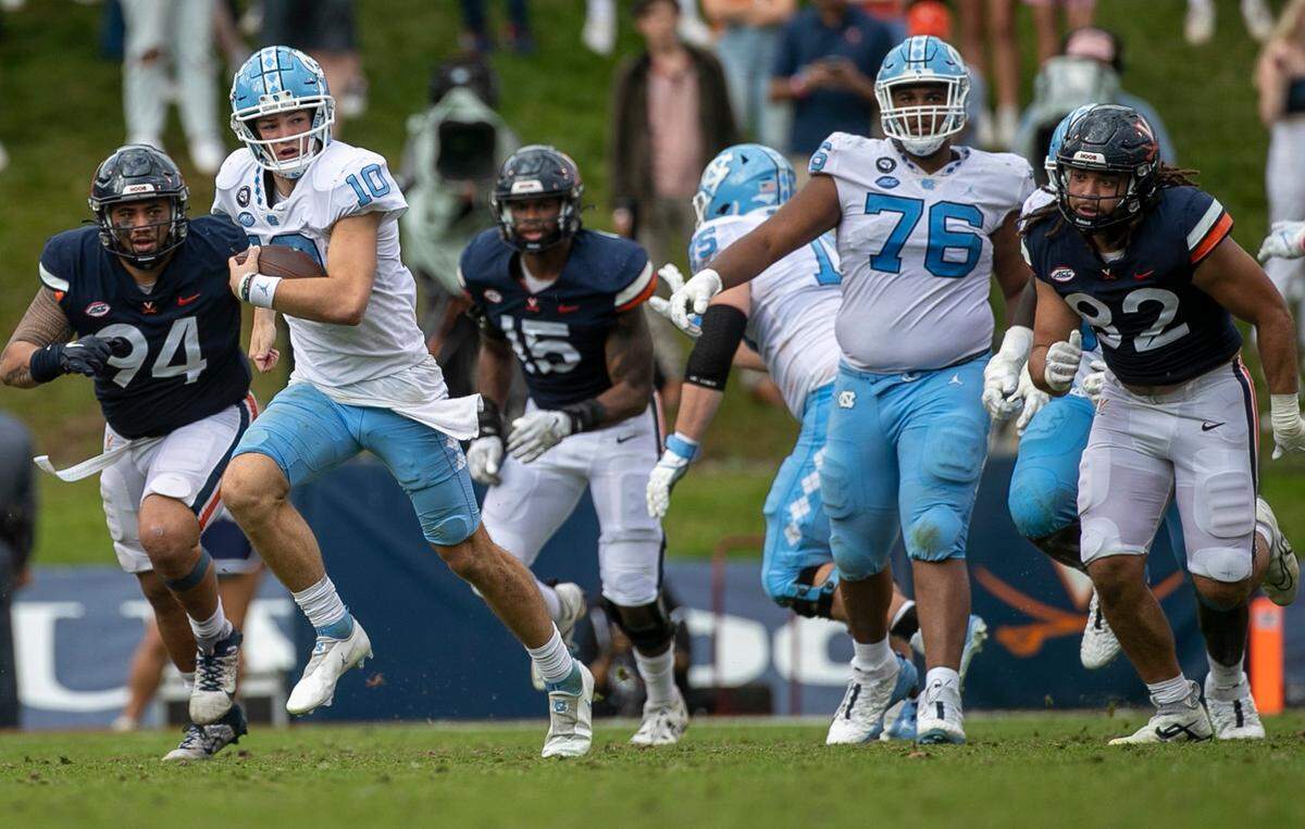 North Carolina quarterback Drake Maye (10) breaks open for a 21-yard gain in the third quarter on Saturday, November 5, 2022 at Scott Stadium in Charlottesville, Va. Maye rushed for 74 yards in the Tar Heels’ victory.