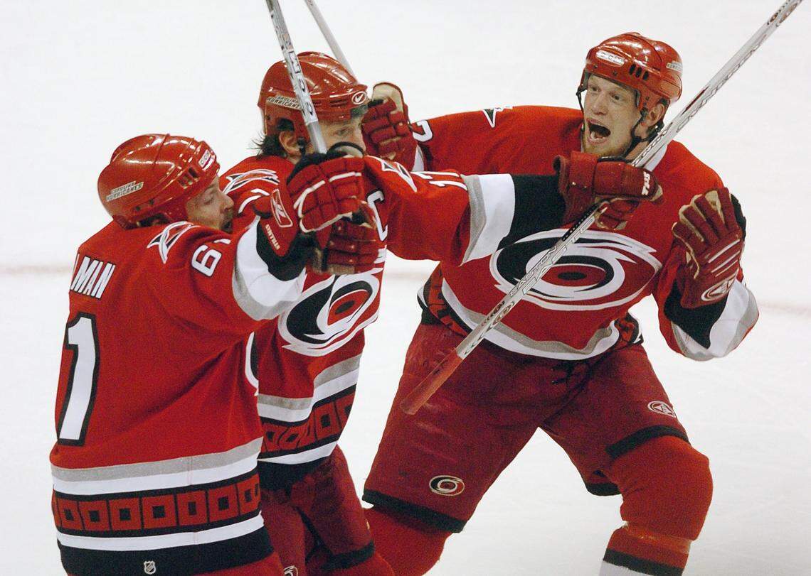 From left, Carolina Hurricanes Cory Stillman, Rod Brind’Amour and Eric Staal celebrate after Brind’Amour’s game-winning goal in the third period in the Hurricanes 4-2 win over the Buffalo Sabres in game 7 of the Eastern Conference Finals June 1, 2006 at the RBC Center.