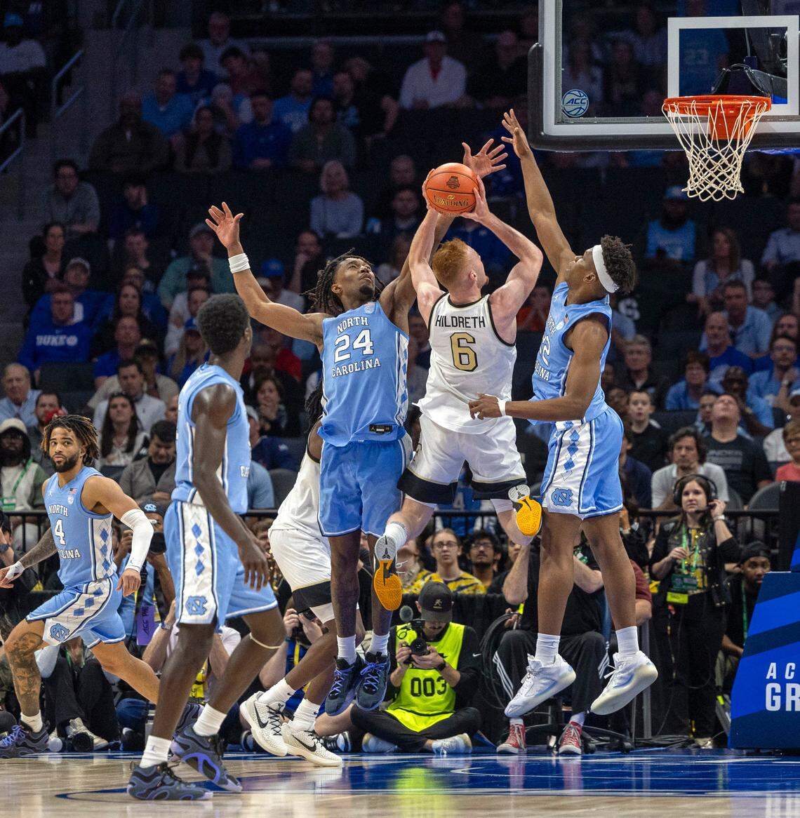 North Carolina forward Ven-Allen Lubin (22) and Jae’Lyn Withers (24) defend Wake Forest’s Cameron Hildreth (6) in the final minutes if play, preventing a score, to enable the Tar Heels’ 68-59 victory on Thursday, March 13, 2025 during the quarterfinals of the ACC Tournament at Spectrum Center in Charlotte, N.C.