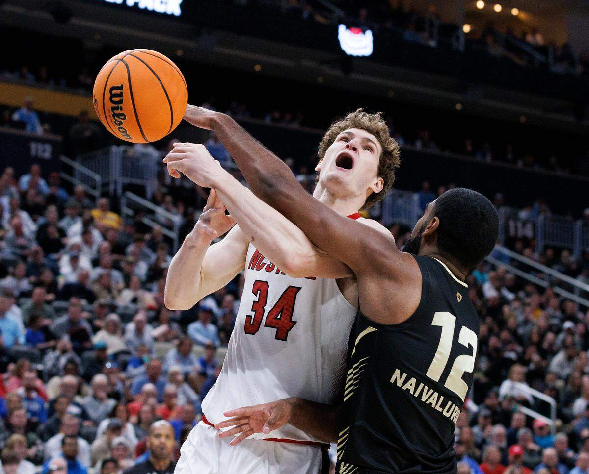 N.C. State’s Ben Middlebrooks is fouled by Oakland’s Tuburu Naivalurua during the second half of the Wolfpack’s 79-73 overtime win in the second round of the NCAA Tournament on Saturday, March 23, 2024, at PPG Paints Arena in Pittsburgh, Pa.