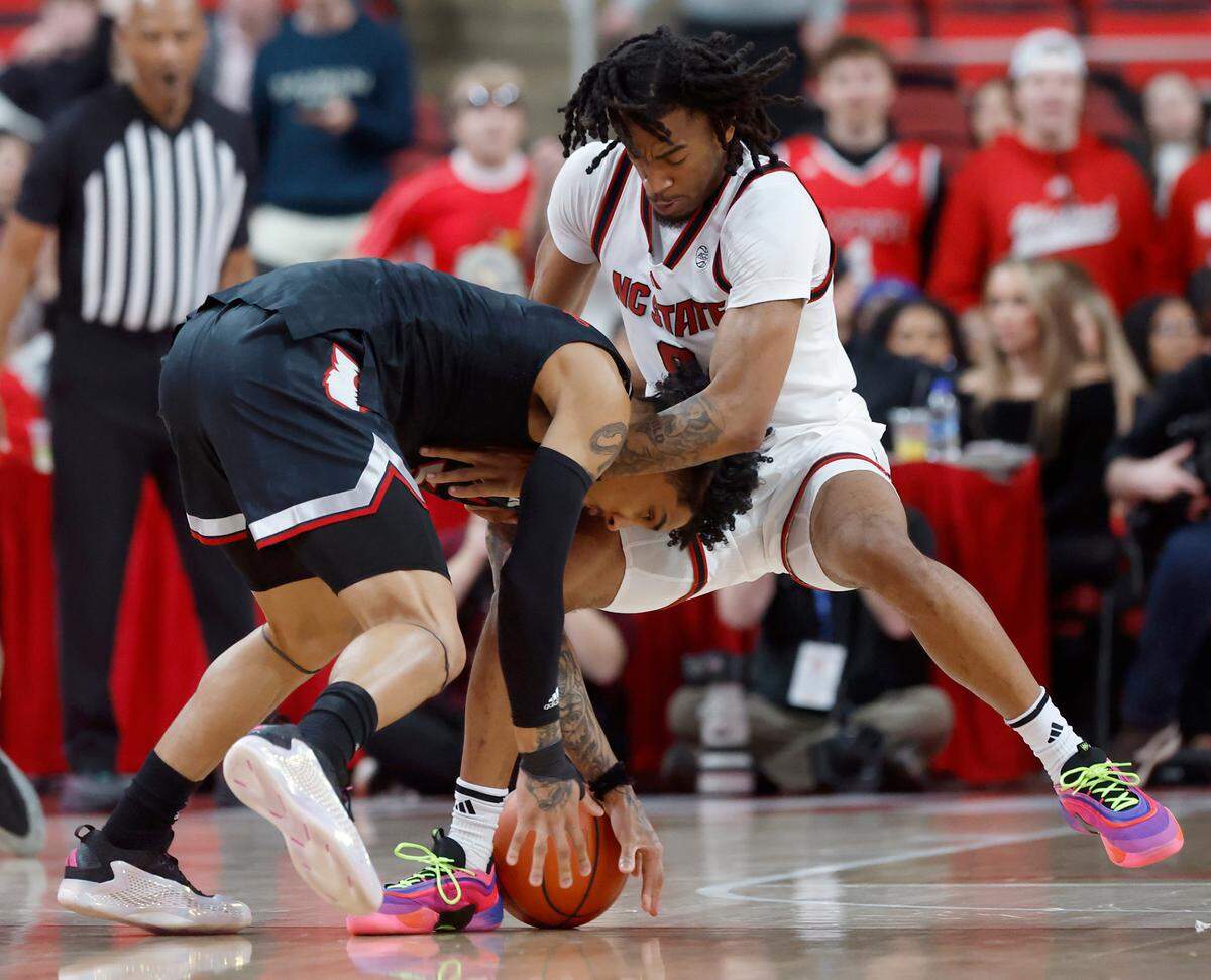 N.C. State’s Jayden Taylor pressures Louisville’s Terrence Edwards Jr. during the first half of the Wolfpack’s 91-66 loss on Wednesday, Feb. 12, 2025, at Lenovo Center in Raleigh, N.C.