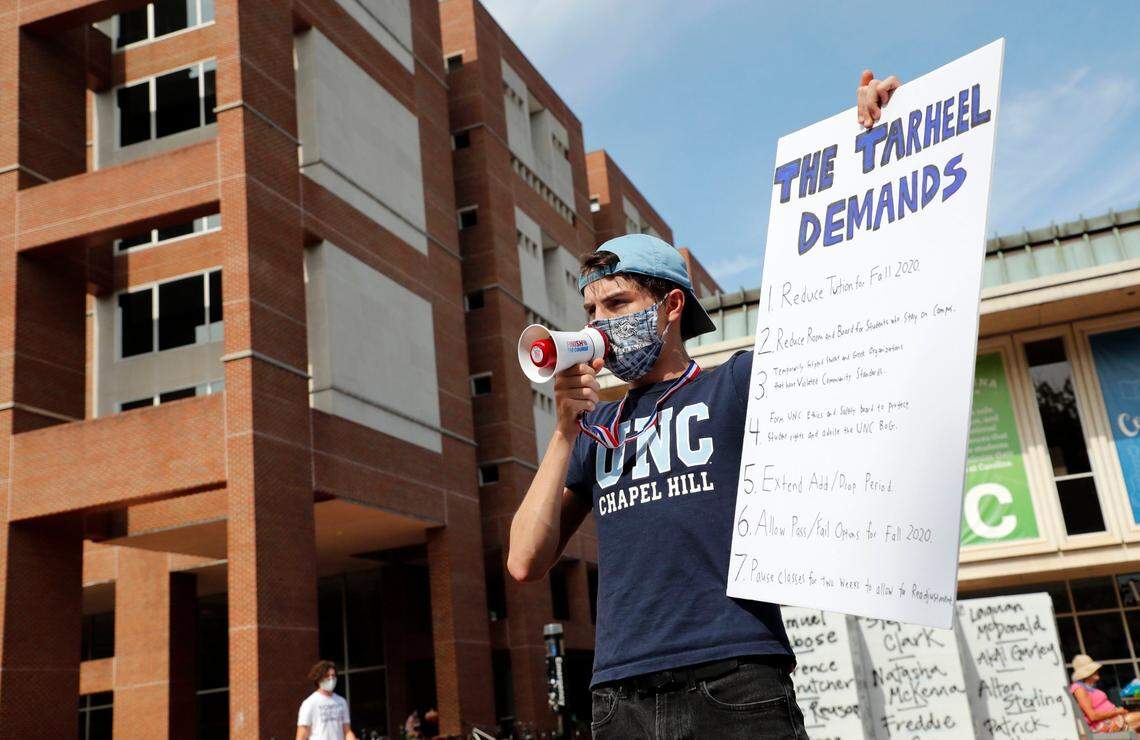 Garrett Tucker, a UNC-Chapel Hill sophomore from Charlotte, protests at “The Pit” on the campus of UNC in Chapel Hill, N.C., Tuesday, August 18, 2020. Tucker and his roommates Michael Metcalf and Adalgeovany Caceres are part of a group called The Tarheel Demands, who have a created a list of actions they would like seen taken.