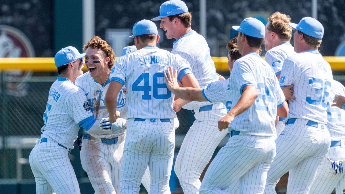 Jun 14, 2024; Omaha, NE, USA; The North Carolina Tar Heels celebrate after a walk off RBI single by center fielder Vance Honeycutt (7) against the Virginia Cavaliers at Charles Schwab Field in Omaha.