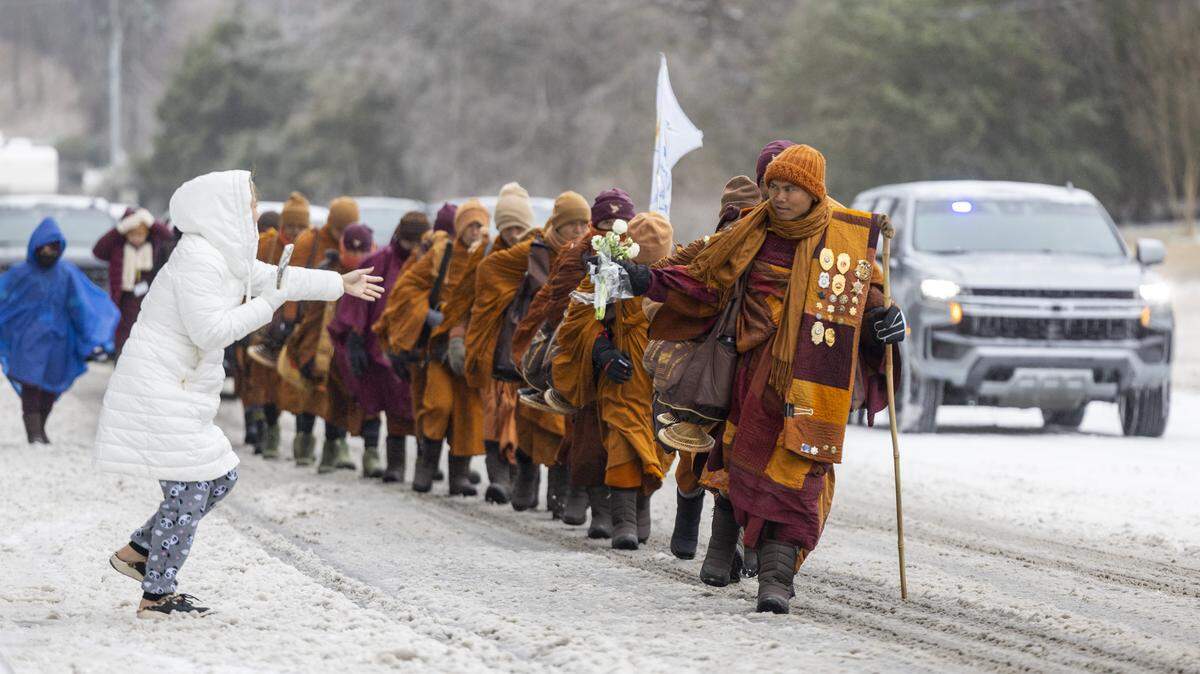 Despite winter weather conditions, a procession of Buddhist monks walks along Buffaloe Road on Sunday, Jan. 25, 2026, in Raleigh. The monks are making a 2,300-mile pilgrimage from Texas to Washington, D.C., as part of the Walk for Peace, an effort to promote peace, compassion and national unity.