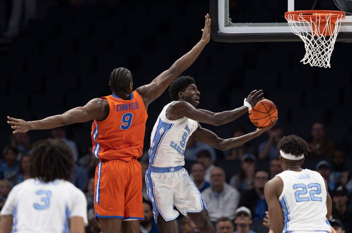 North Carolina forward Drake Powell (9) breaks to the basket against Florida’s Reuben Chinyelu (9) in the first half during the Jumpman Invitational on Tuesday, December 17, 2024 at the Spectrum Center in Charlotte, N.C.