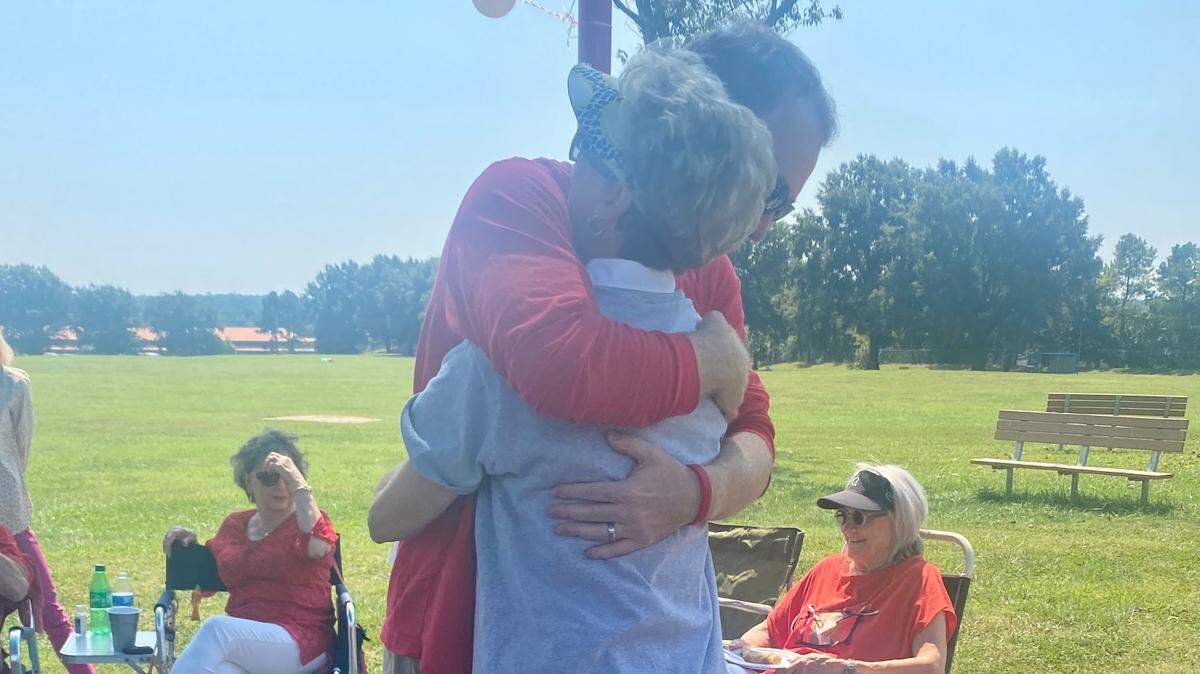 Mark Banks hugs his mother, Robin, as they celebrate his brother and her son Andy’s life one year after he was slain while selling a car on Craigslist.