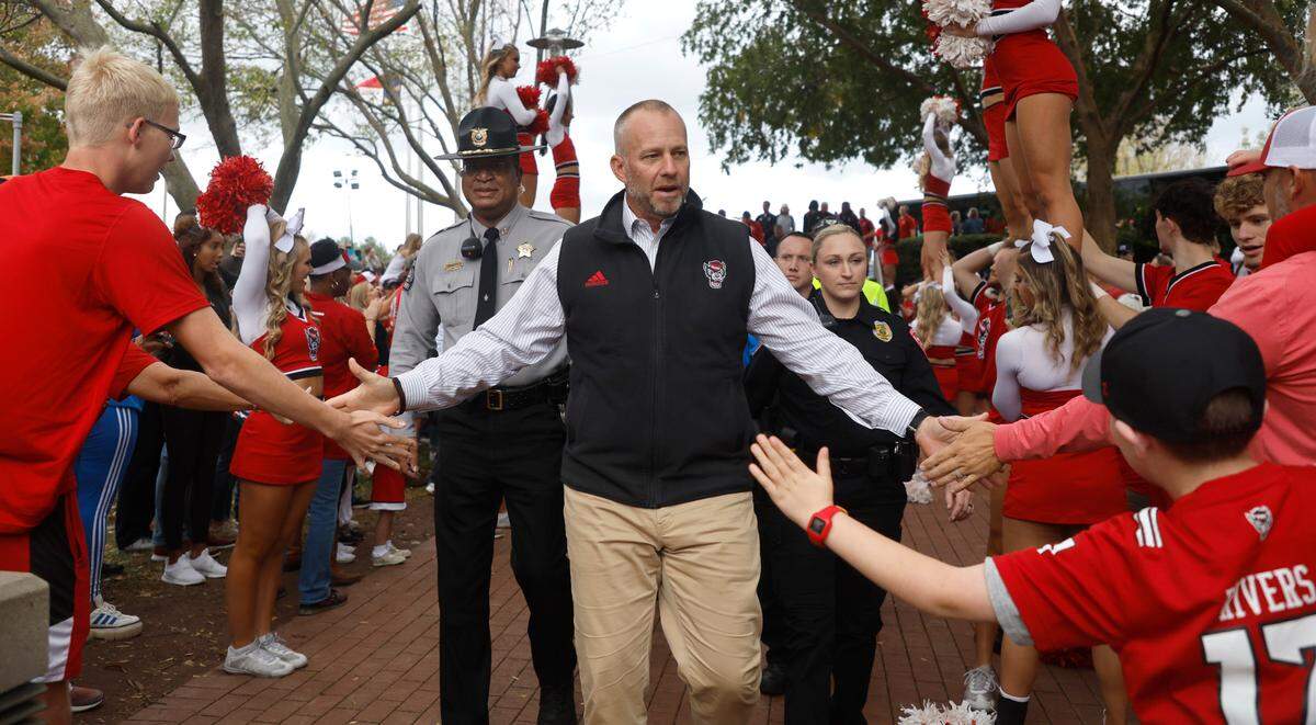 N.C. State head coach Dave Doeren greets fans during the Walk of Champions before N.C. State’s game against Boston College at Carter-Finley Stadium in Raleigh, N.C., Saturday, Nov. 12, 2022.