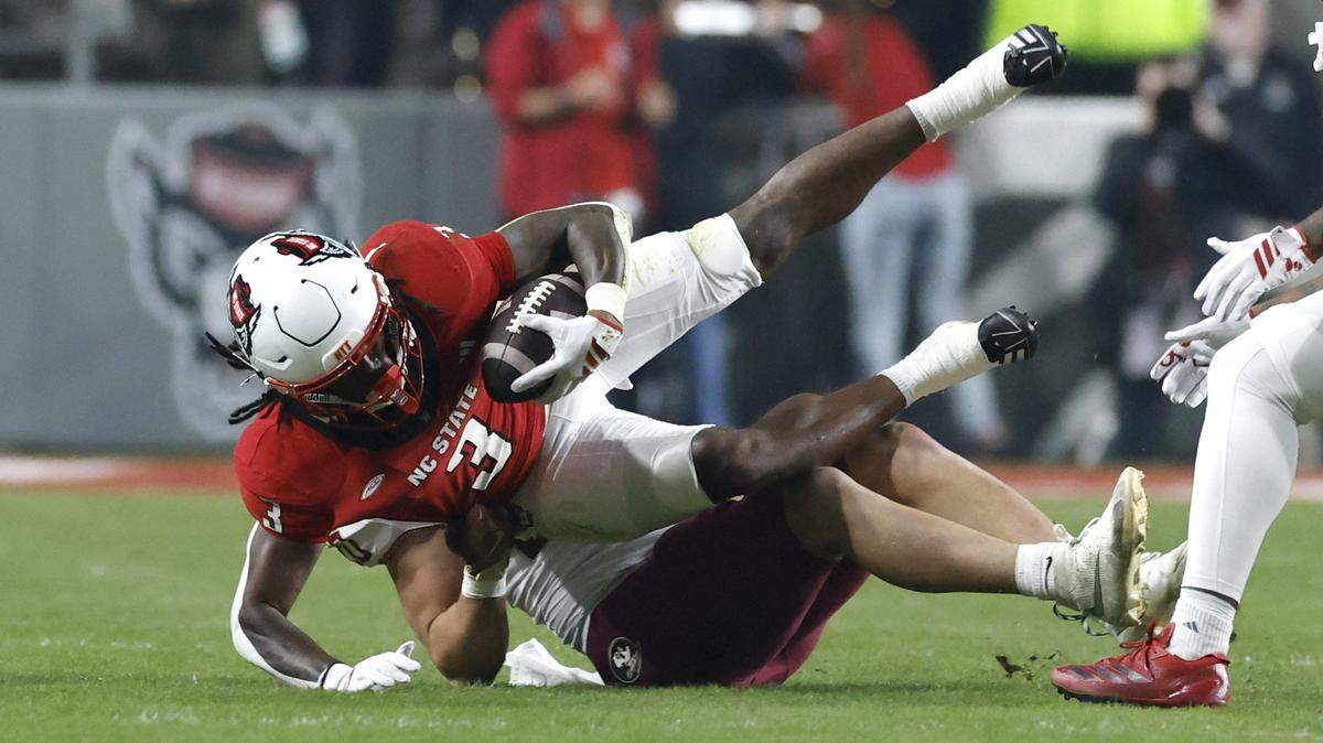 Florida State linebacker Blake Nichelson (20) tackles N.C. State running back Hollywood Smothers (3) during the first half of N.C. State’s game against Florida State at Carter-Finley Stadium in Raleigh, N.C., Friday, Nov. 21, 2025.
