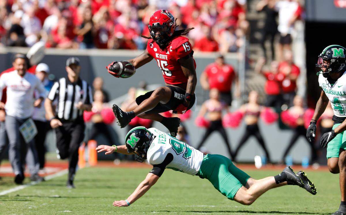 N.C. State wide receiver Keyon Lesane (15) hurdles over Marshall kicker Rece Verhoff (90) on a kickoff return during the first half of N.C. State’s game against Marshall at Carter-Finley Stadium in Raleigh, N.C., Saturday, Oct. 7, 2023.