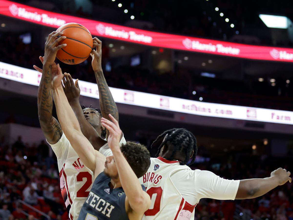 North Carolina State’s Ernest Ross pulls down a rebound away from Georgia Tech’s Lance Terry during the second half of the Wolfpack’s 72-64 win over Georgia Tech at PNC Arena on Saturday, Feb. 4, 2023, in Raleigh, N.C.