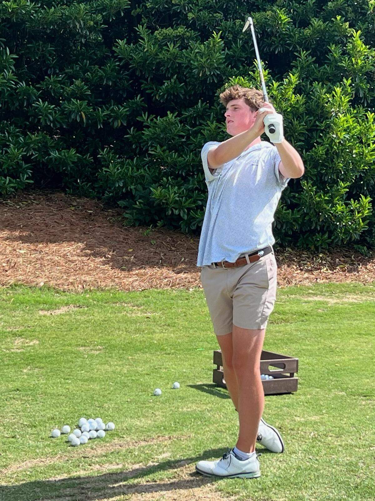 Andrew Neal hits a ball on the range at MacGregor Downs Country Club in Cary, North Carolina. Neal will try to help lead Cary Christian to a state title this week.
