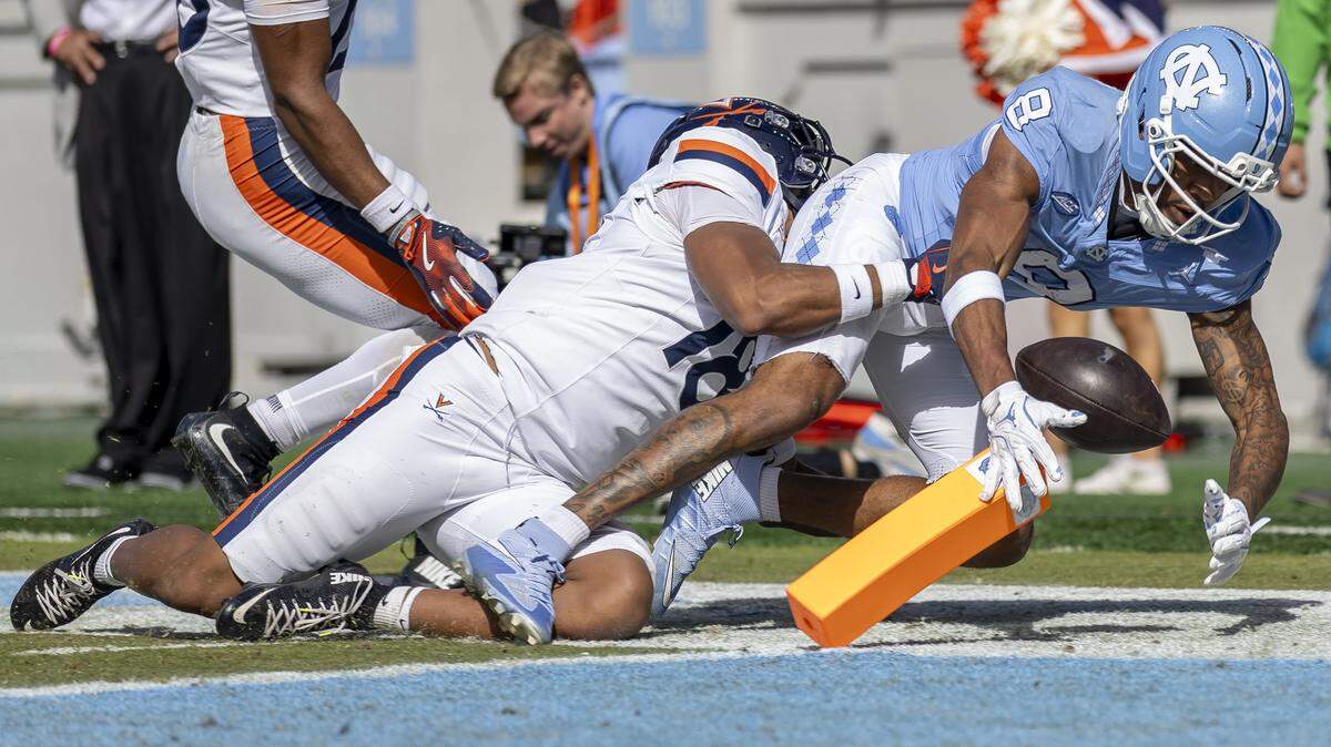 North Carolina wide receiver Kobe Paysour (8) fumbles the ball as he crosses the goal line, turning the ball over to Virginia on a touchback, in the first quarter on Saturday, October 25, 2025 at Kenan Stadium in Chapel Hill, N.C. 