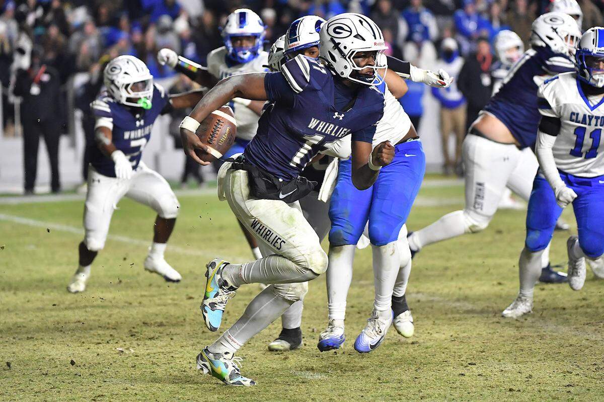 Grimsley quarterback Faizon Brandon (11) runs for yards against Clayton during the second half.  The Clayton Comets and the Grimsley Whirlies met in the NCHSAA 7A football Championships in Chapel Hill, NC on December 12, 2025.