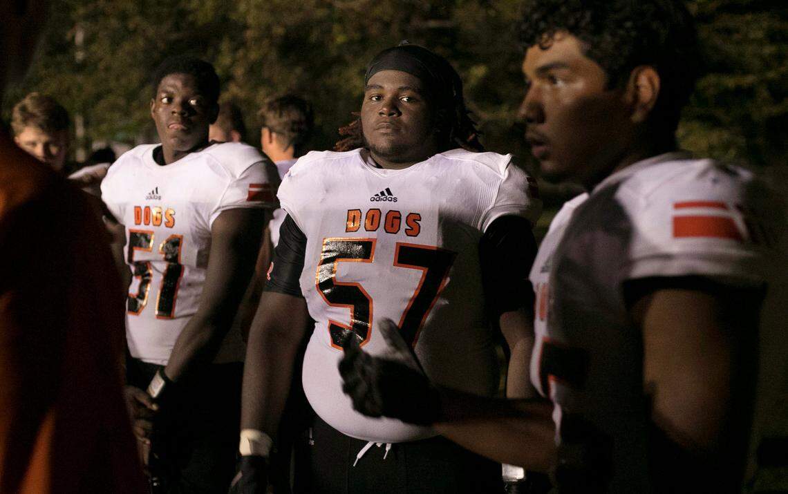 Wallace-Rose Hill’s Raekwon Bryant (51), Deunta Cromity (57) and Gerson Sosa (75) huddle with their coaches during halftime of their game against Spring Creek on Friday, October 5, 2018 in Seven Springs, N.C.
