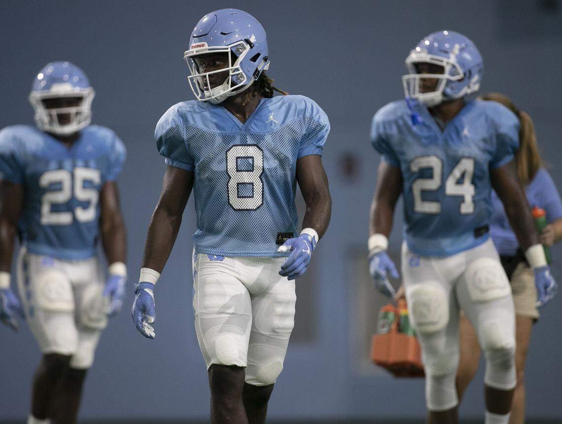 North Carolina running backs Javonte Williams (25), Michael Carter (8) and Antonio Williams (24) line up for pass reception rotation during the Tar Heels’ practice on Tuesday, August 6, 2019 at the Football Practice Facility in Chapel Hill, N.C.