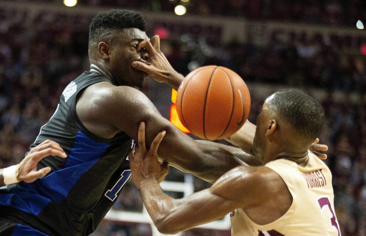 Florida State guard Trent Forrest, right, gets his hand in the face of Duke forward Zion Williamson forcing a turnover in the first half of an NCAA college basketball game in Tallahassee, Fla., Saturday, Jan. 12, 2019. (AP Photo/Mark Wallheiser)